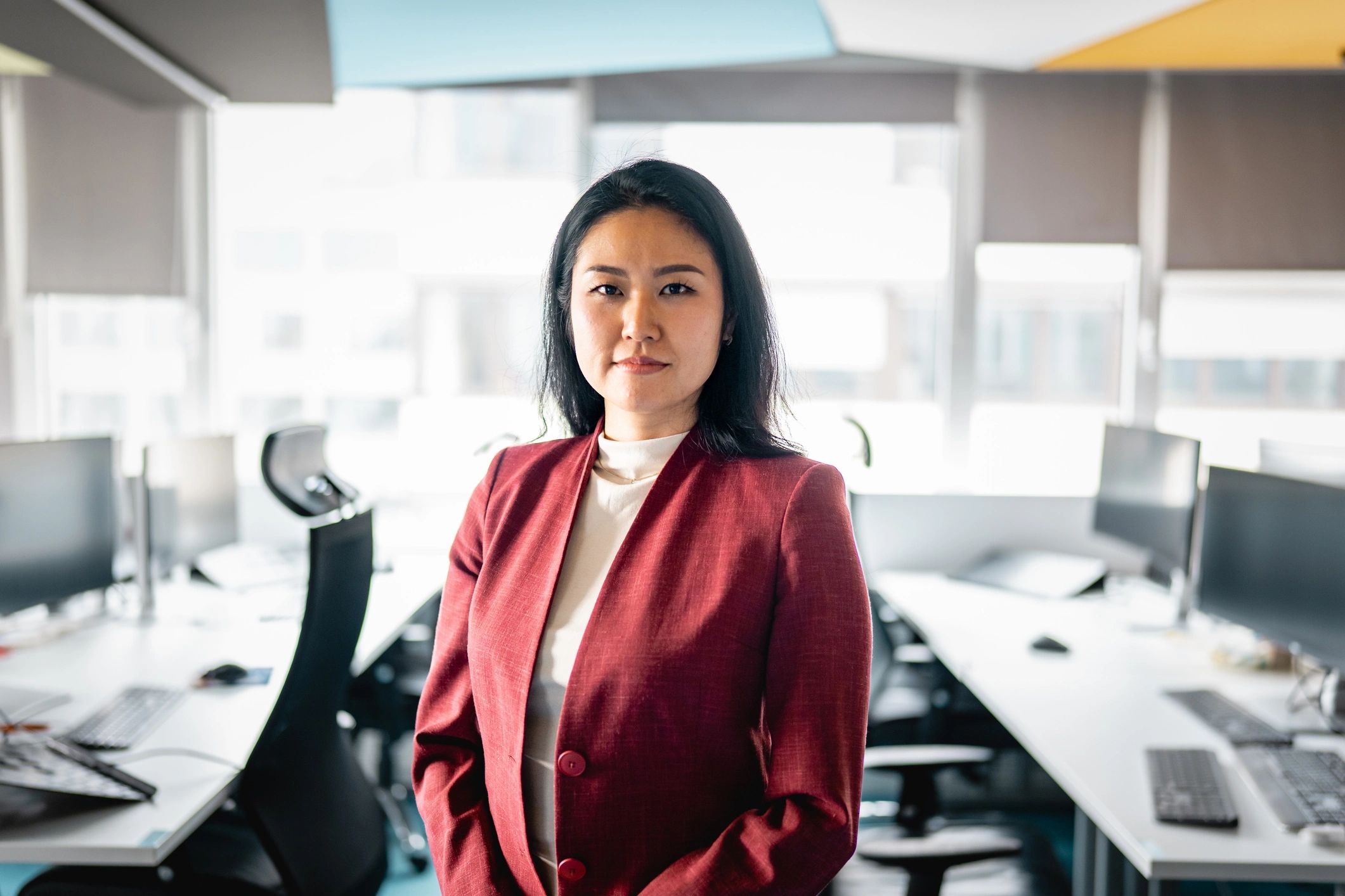 Professional consultant standing confidently in a modern office